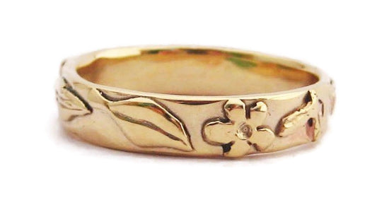 yellow gold floral nature  LGTBQ wedding ring on white background