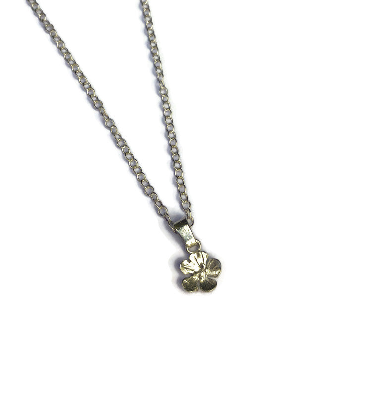 tiny Speedwell wildflower pendant and chain on white background