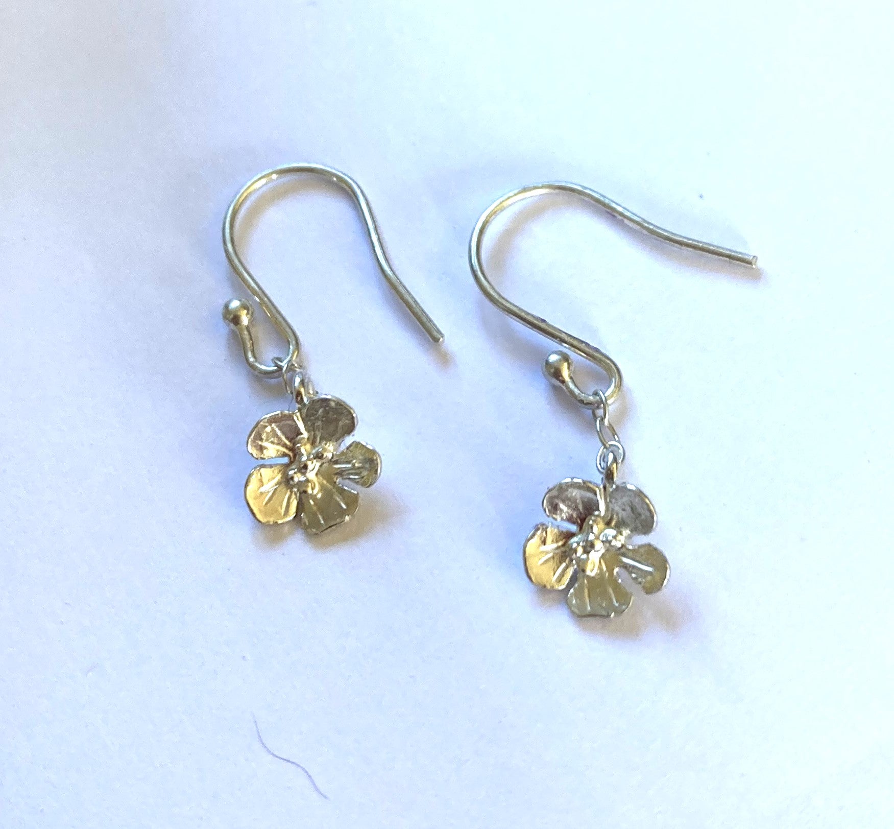 speedwell wildflower design silver hook earrings on grey backround