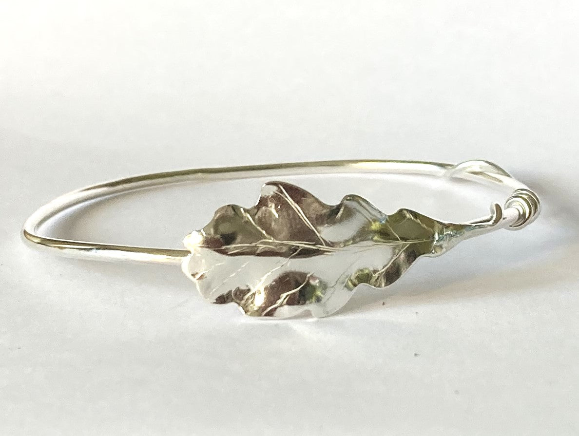 handmade oak leaf bangle in silver on grey background