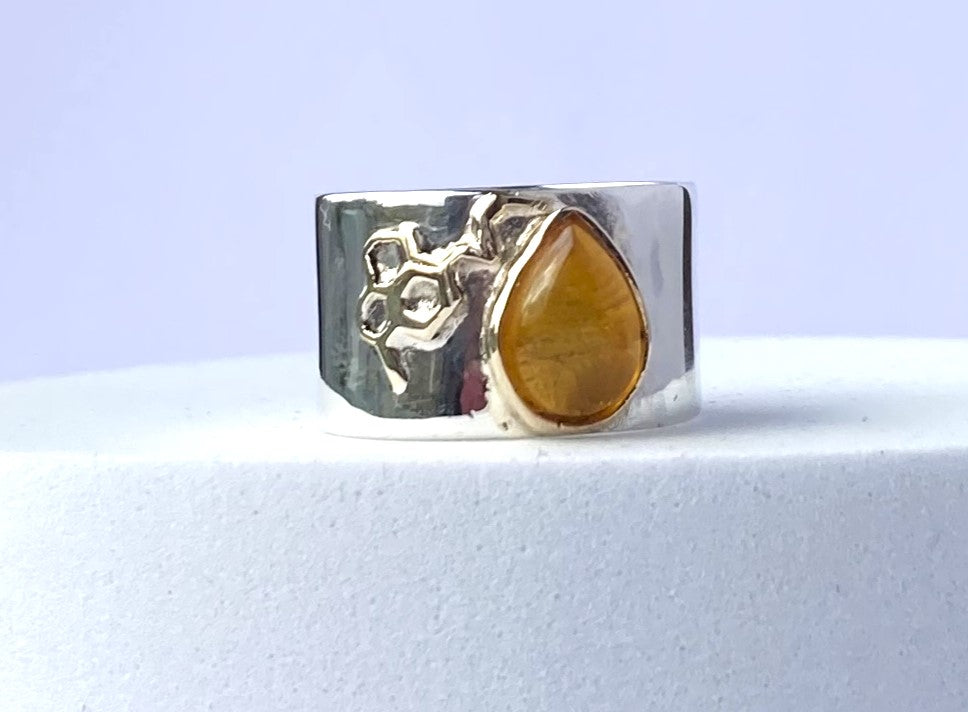 amber and honeycomb detail wide silver ring on white background 