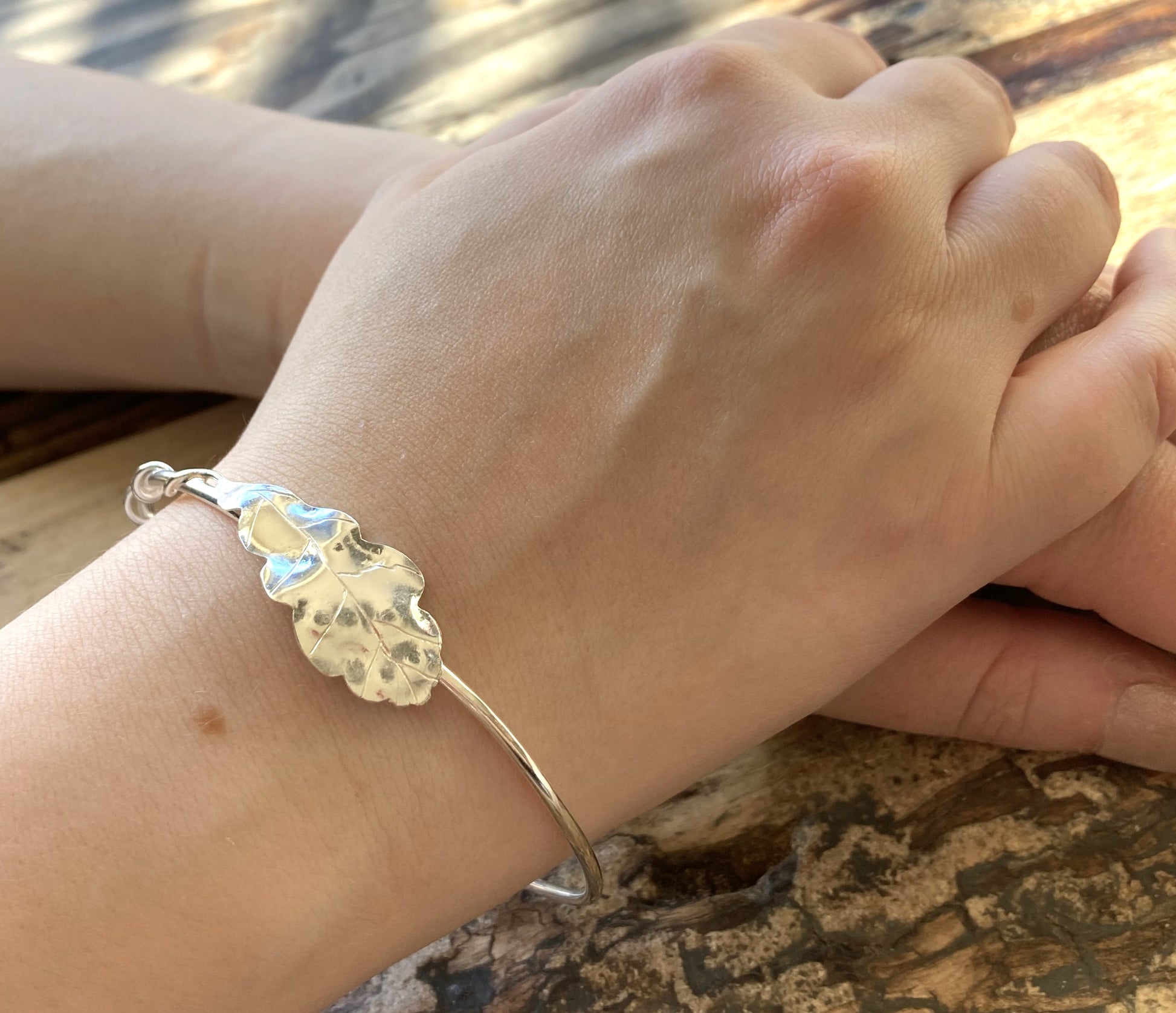 hand forged Oak leaf bangle on ladies wrist