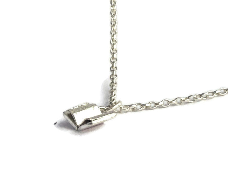 Tiny silver open nook pendant and chain, on white background