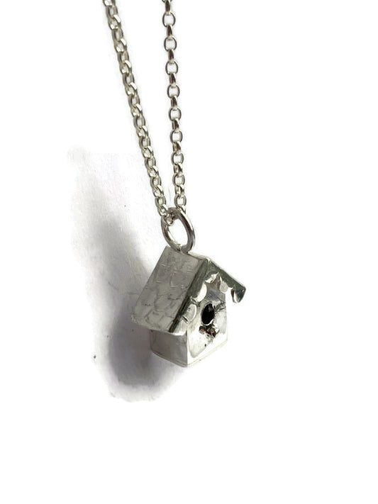 handmade sterling silver birdhouse pendant on white background