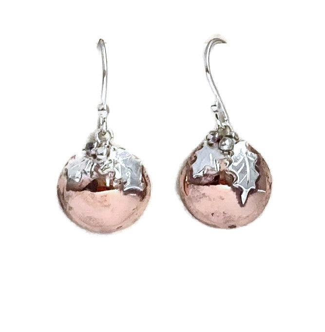 Silver and copper round drop earrings with a Christmas theme , on white background