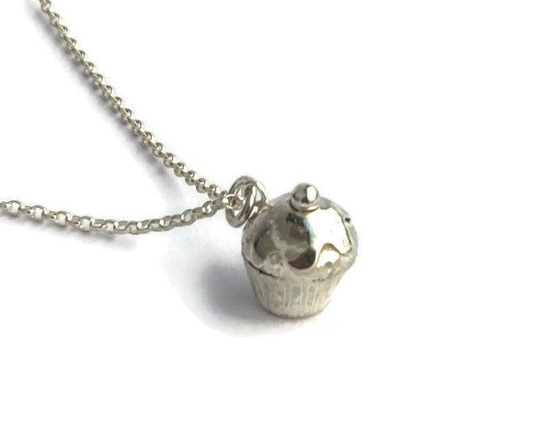 cute tiny silver cherry cupcake pendant on white background