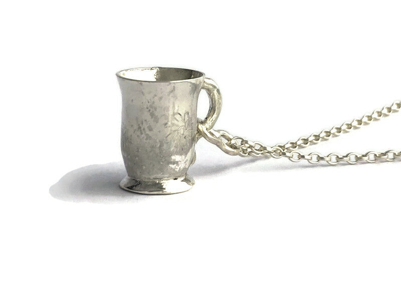 Hand forged sterling silver miniature tea coffee mug pendant, on white background