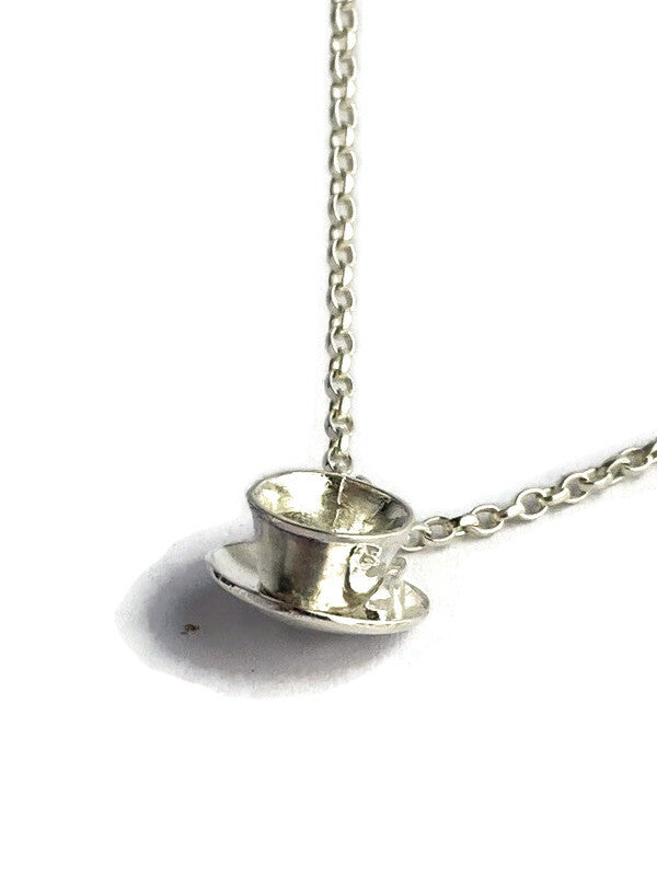 charming silver handmade teacup and chain on white background