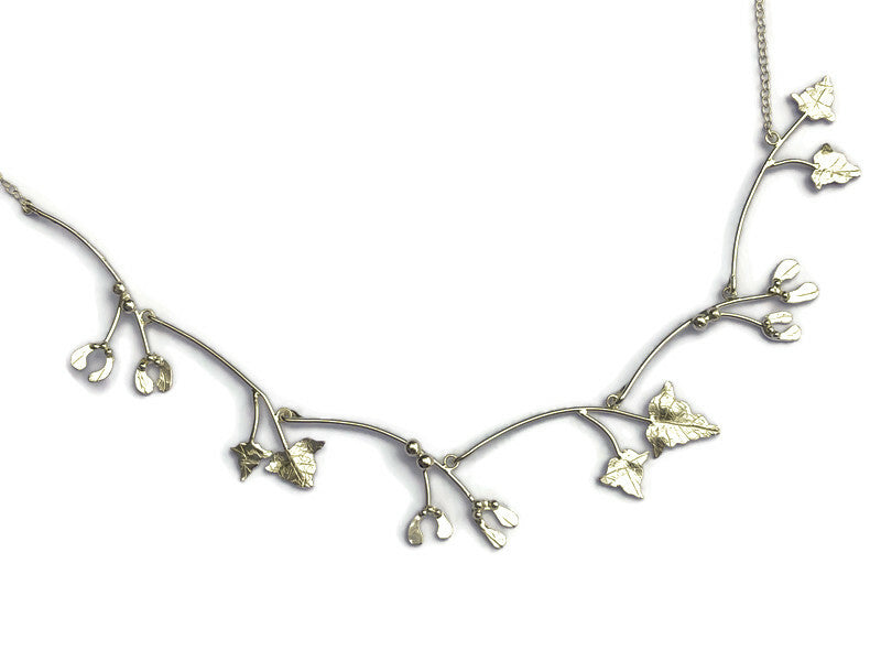 dainty necklace of mistletoe and vine leaves hand made in silver by Kim Styles Jewellery, on white background