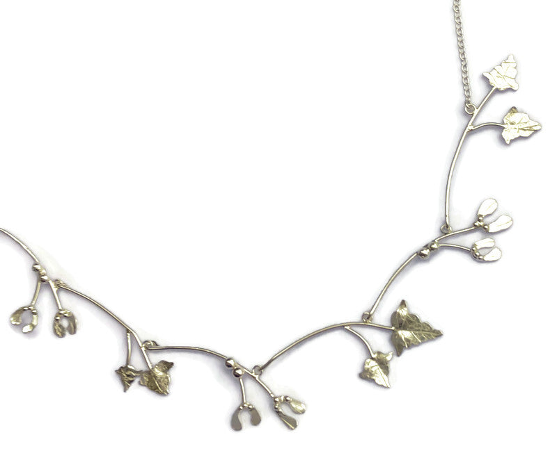 detail of necklet of silver leaves, on white background